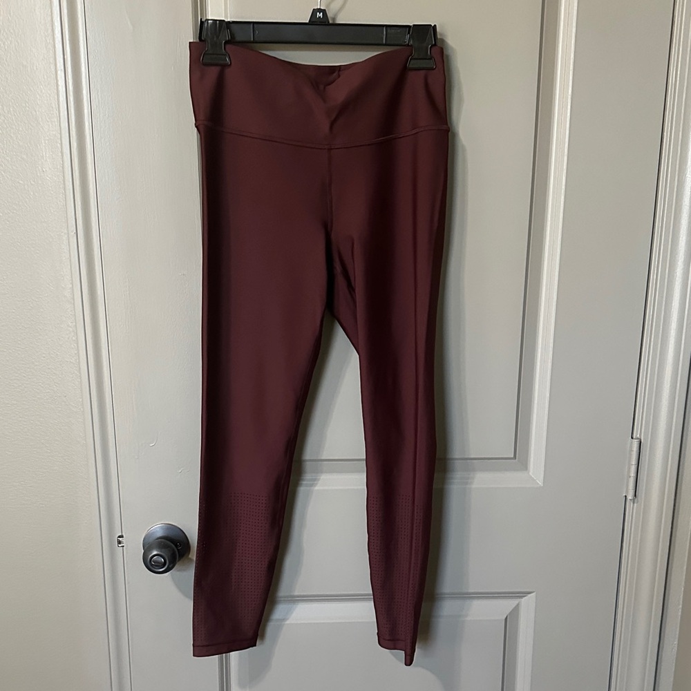 Athleta Interval High Rise Perforated Legging. Size medium. Color is Garnet